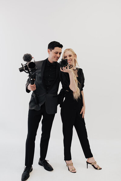 Jessica and Corey behind their cameras, photographed by Erin Marie Photos